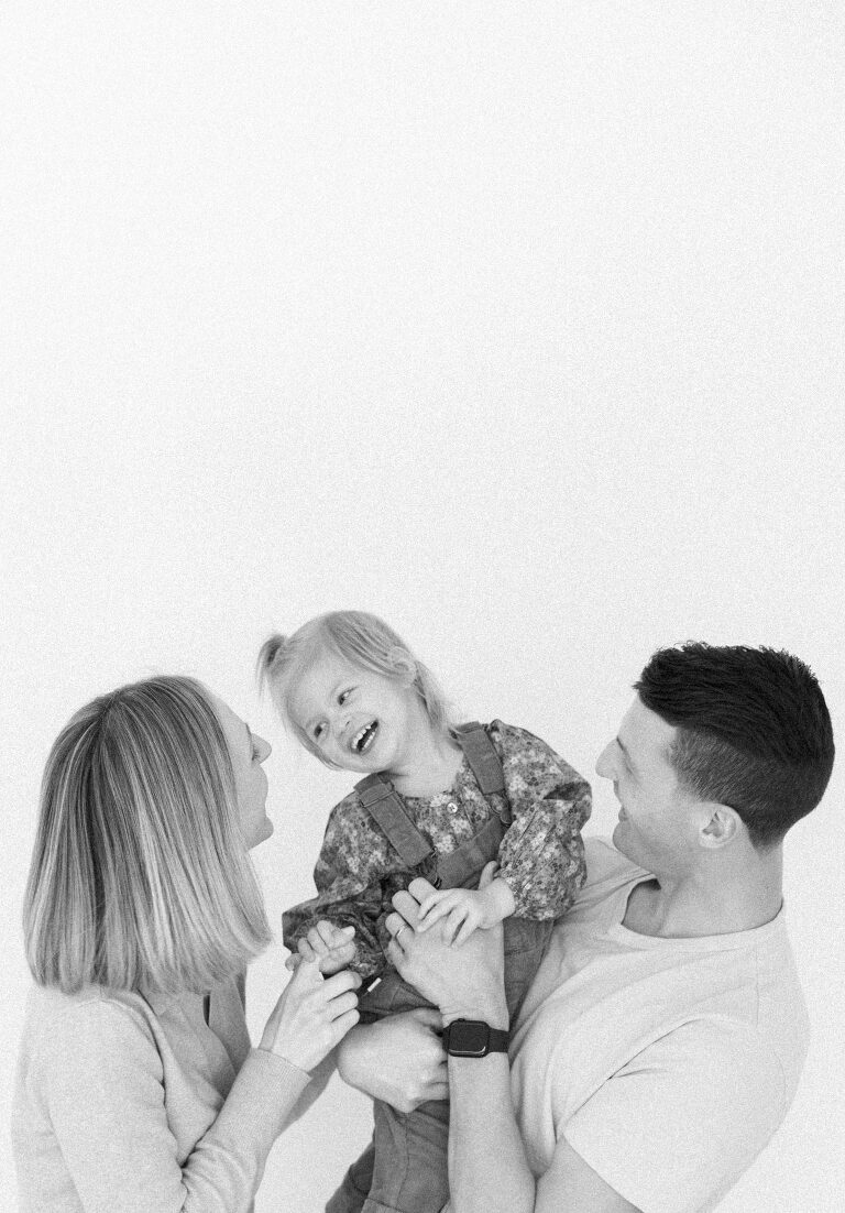 black and white image of a mom and dad and their two year old daughter taken by Asheville family photographer, Haverlee Photography