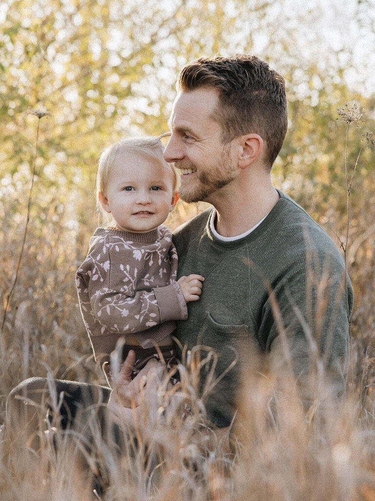 Dad holding two year old daughter at Saylorville Lake family session by Des Moines Family Photographer Haverlee Photography